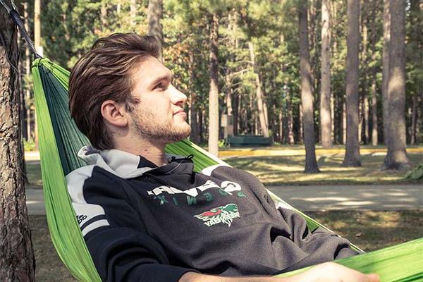 Male student in a hammock on the UWGB Marinette campus